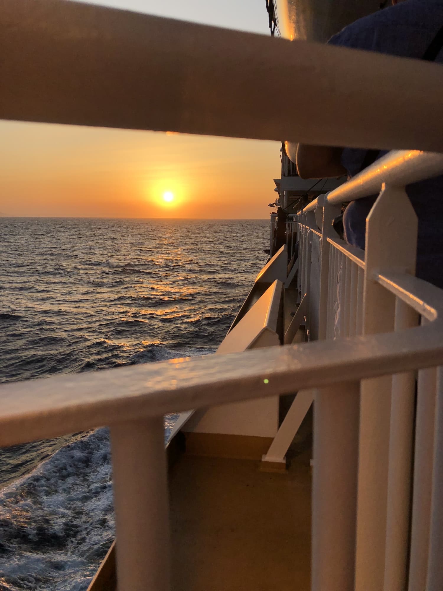 Ferry sunset view, Greece island hopping. Santorini island. Summer sea traveling