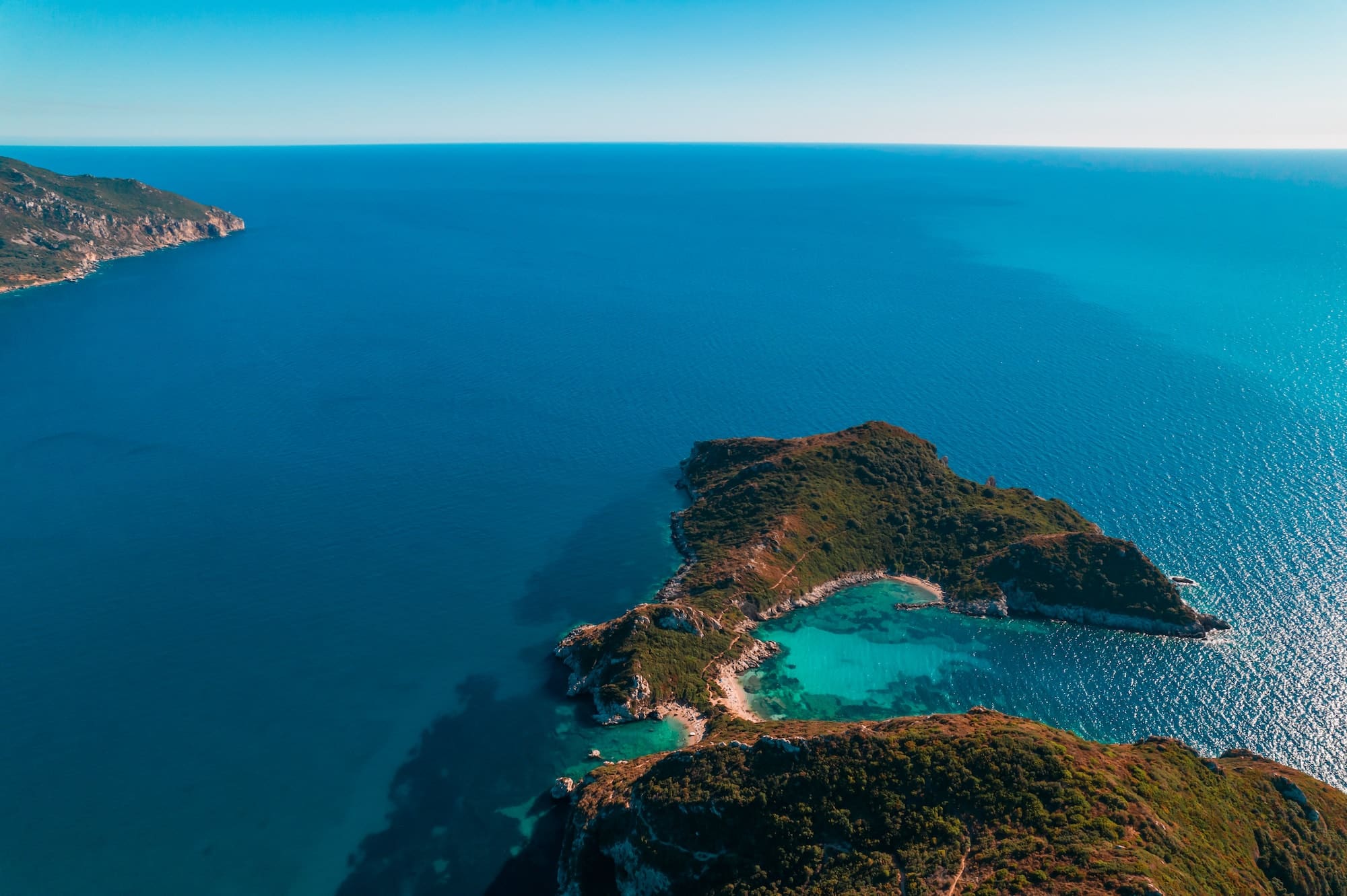 Aerial drone view to Porto Timoni paradise beach with clear teal Ionian sea water. Greece Corfu