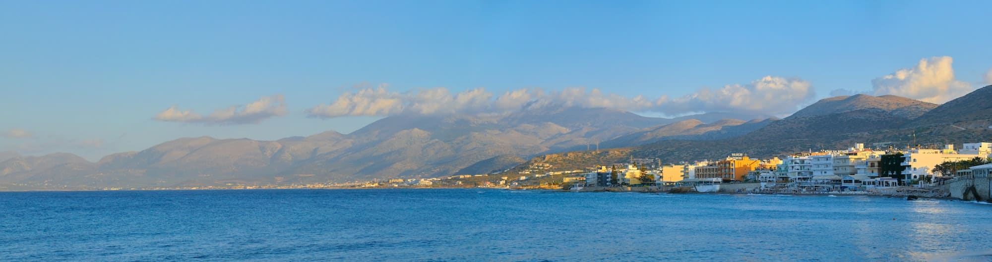 Panoramic view of picturesque harbor of resort village Hersonissos, Greek island of Crete