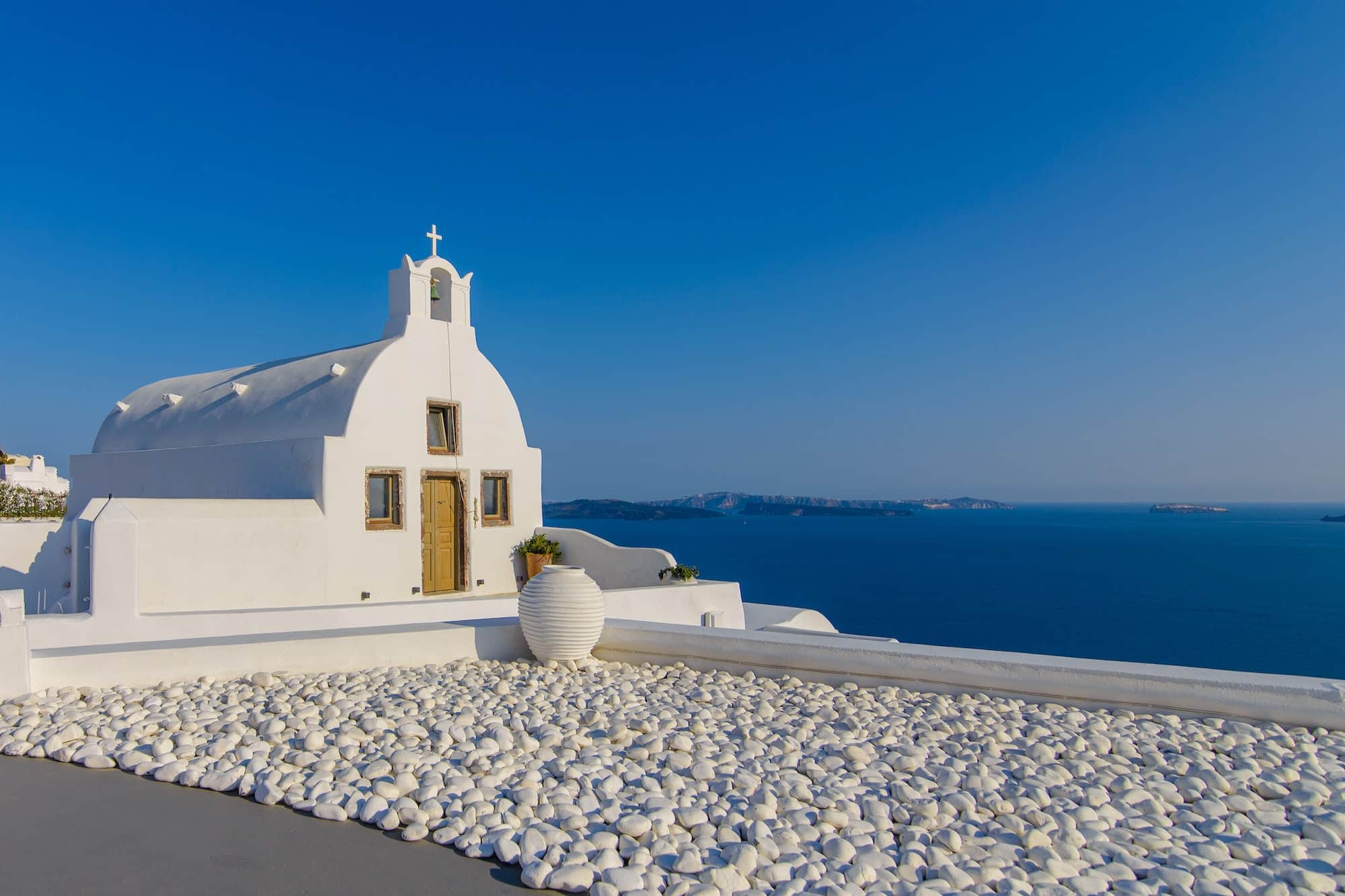 Observation deck and hotel room with views of the sea and the city of Oia, Santorini.