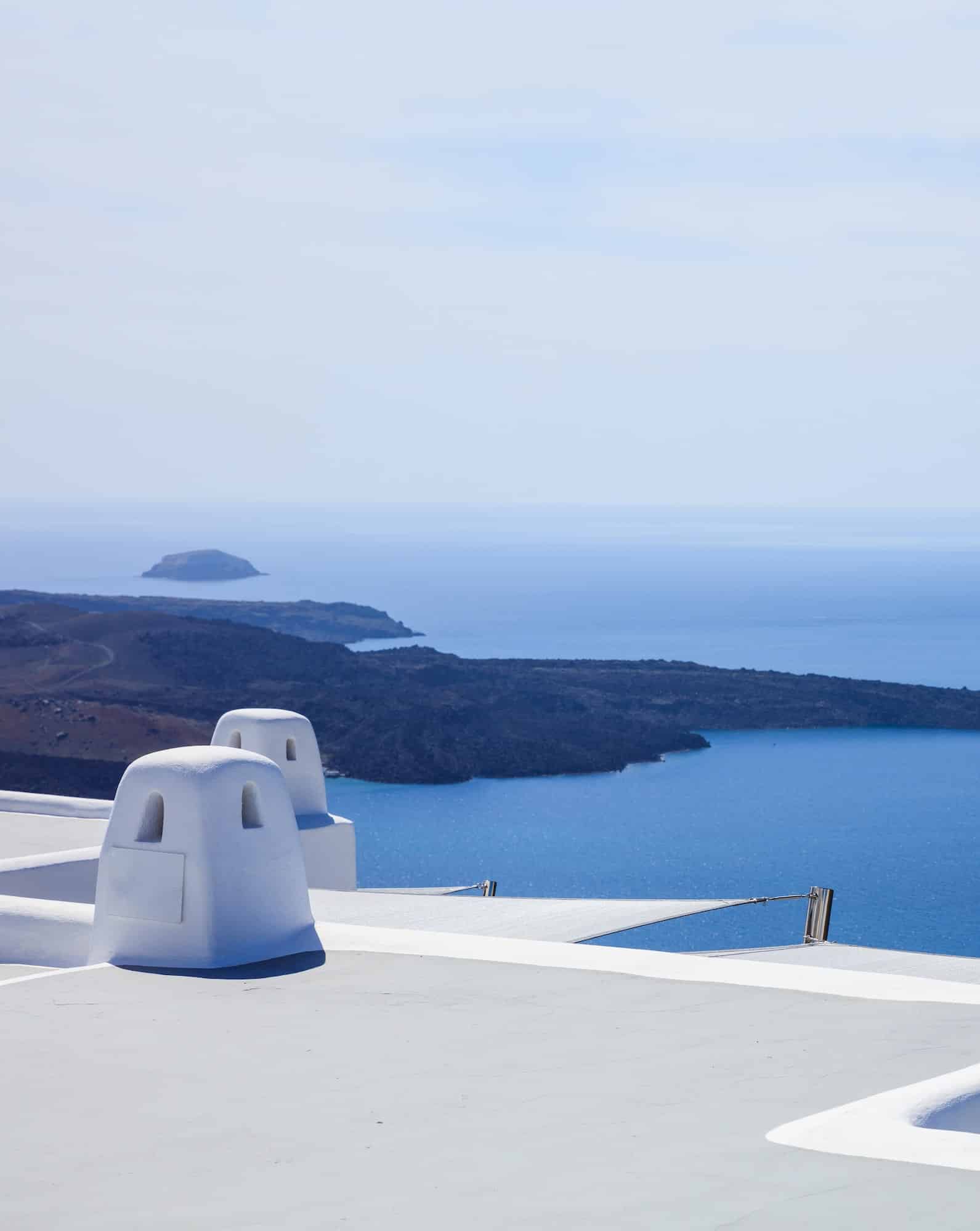 Santorini, Greece. White terrace against blue sea and sky background.