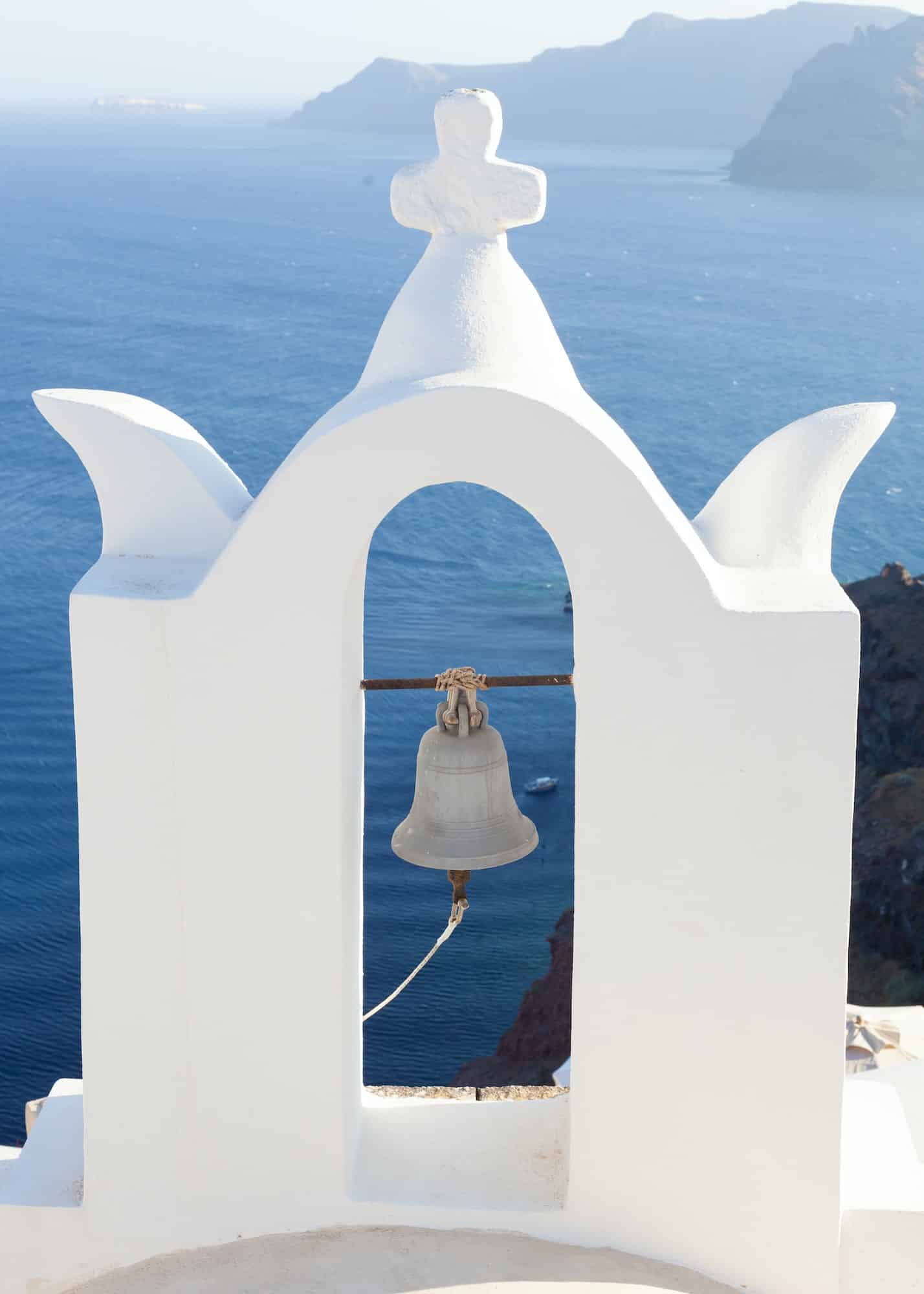 White bell tower at Oia, Santorini, Greece.