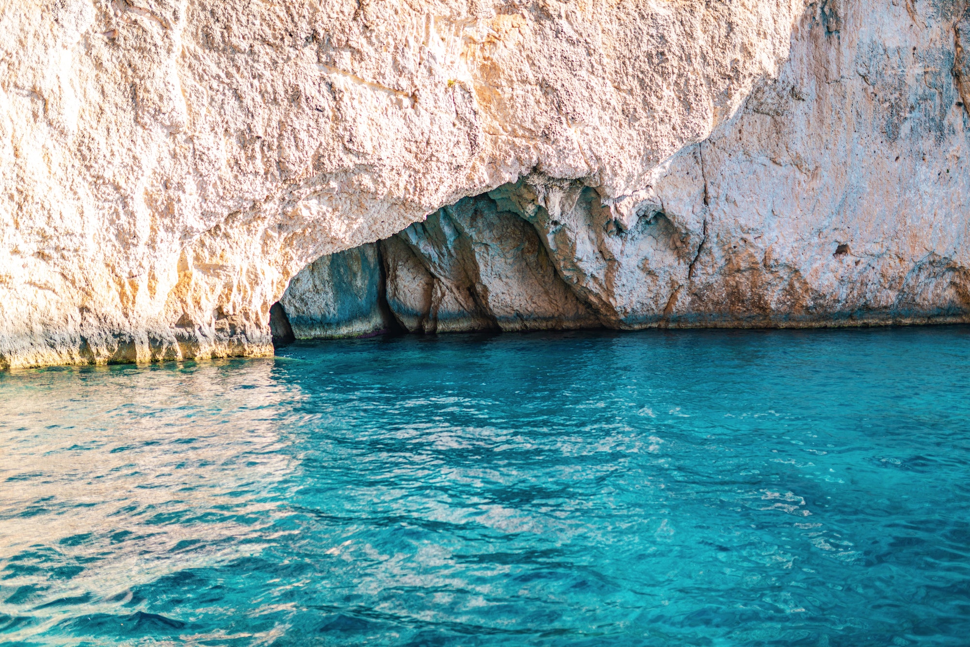 White-stoned rocks creating cave in Corfu island sea beach
