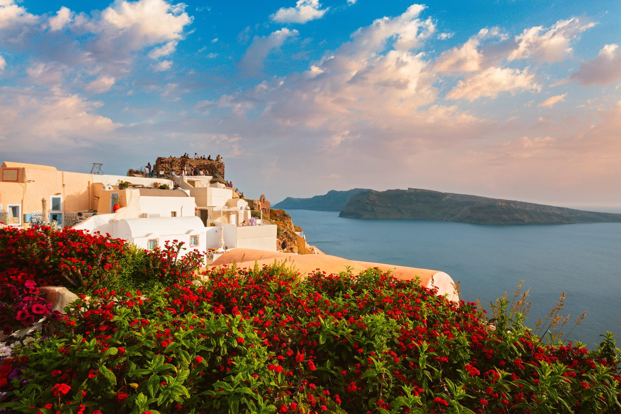 Tourist crowd gathered to watch the sunset in Oia Village, Santorini island, Greece