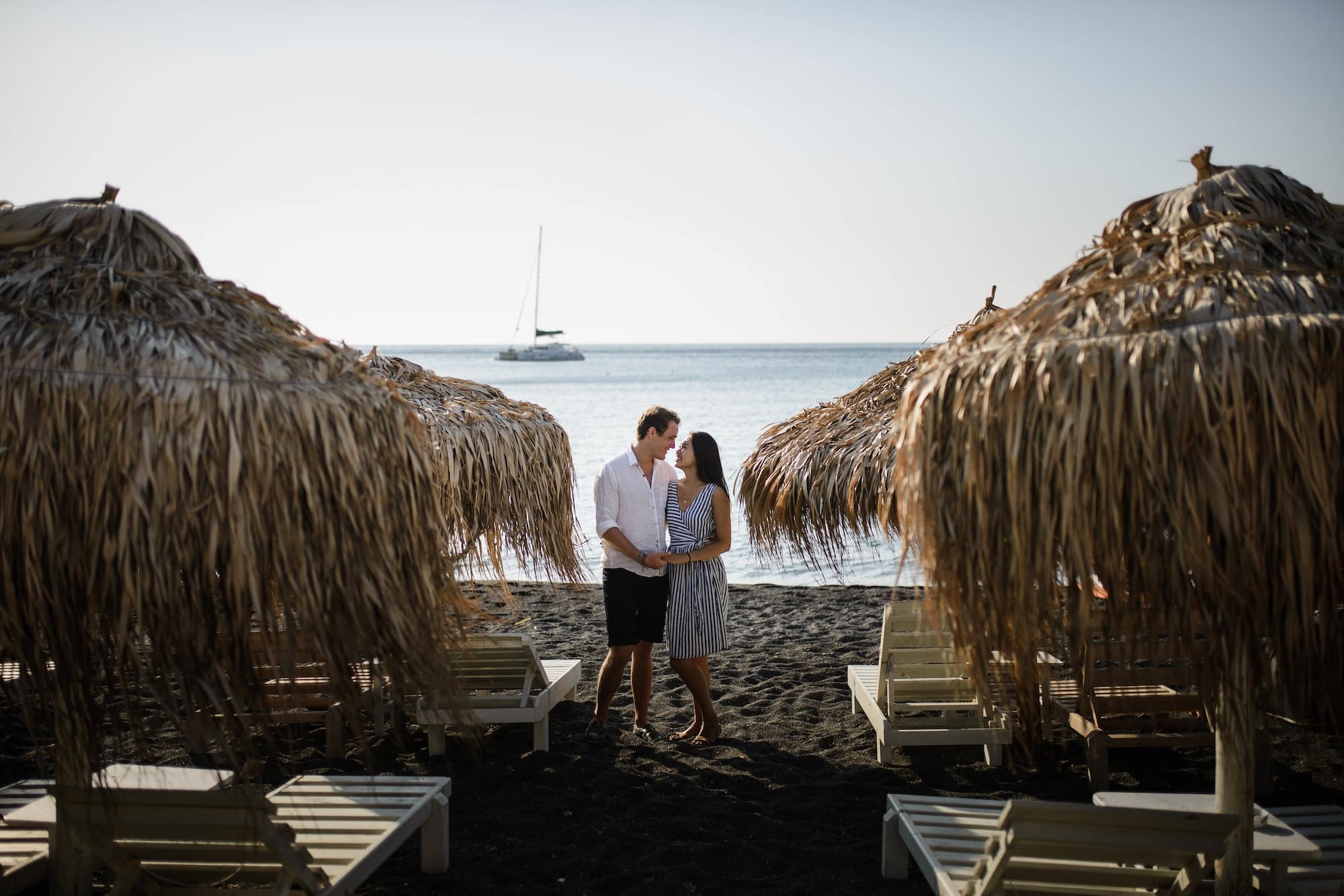 Young couple walking on the background of the sea on the island of Santorini