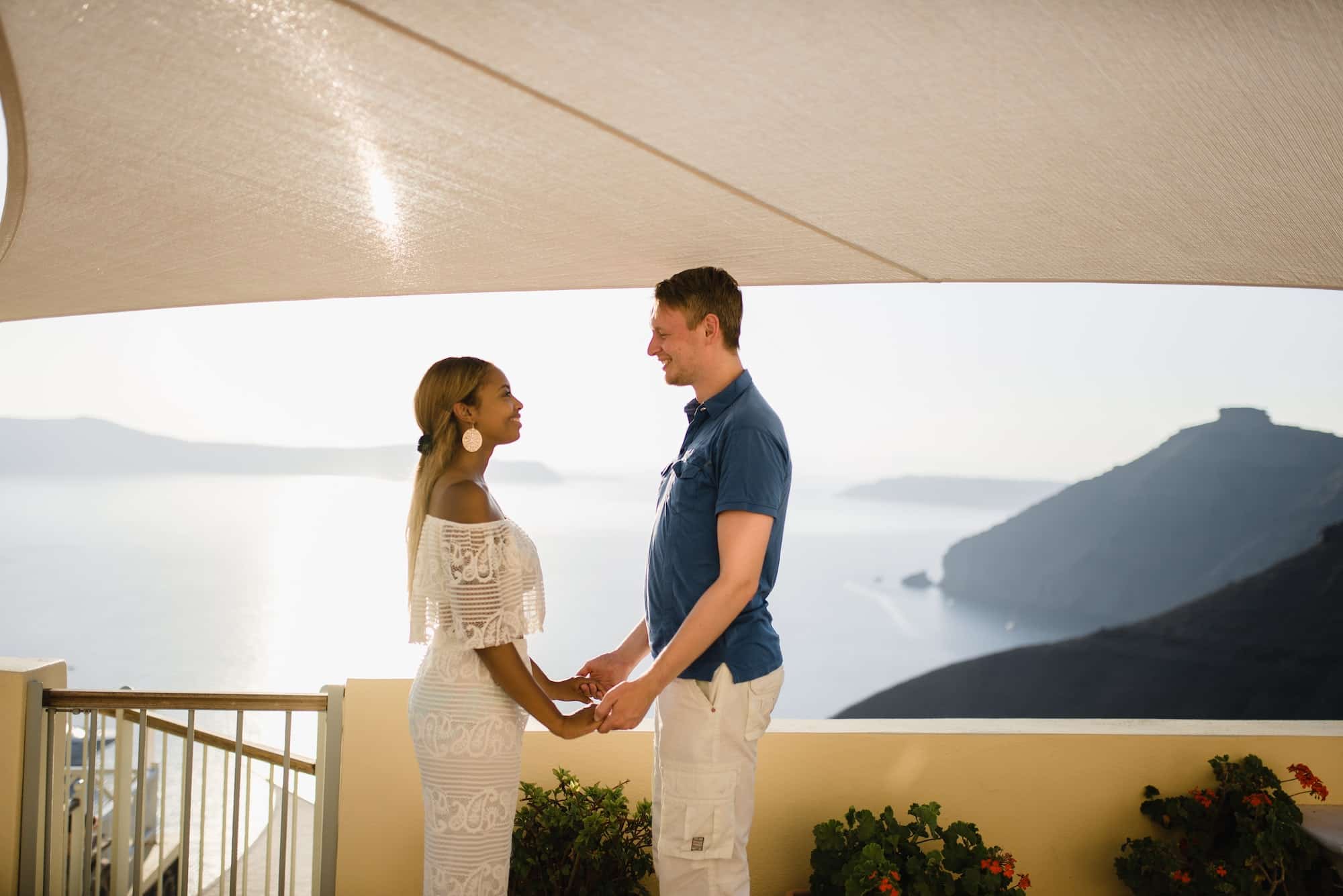 A loving couple walks the streets of the old city on the island of Santorini.