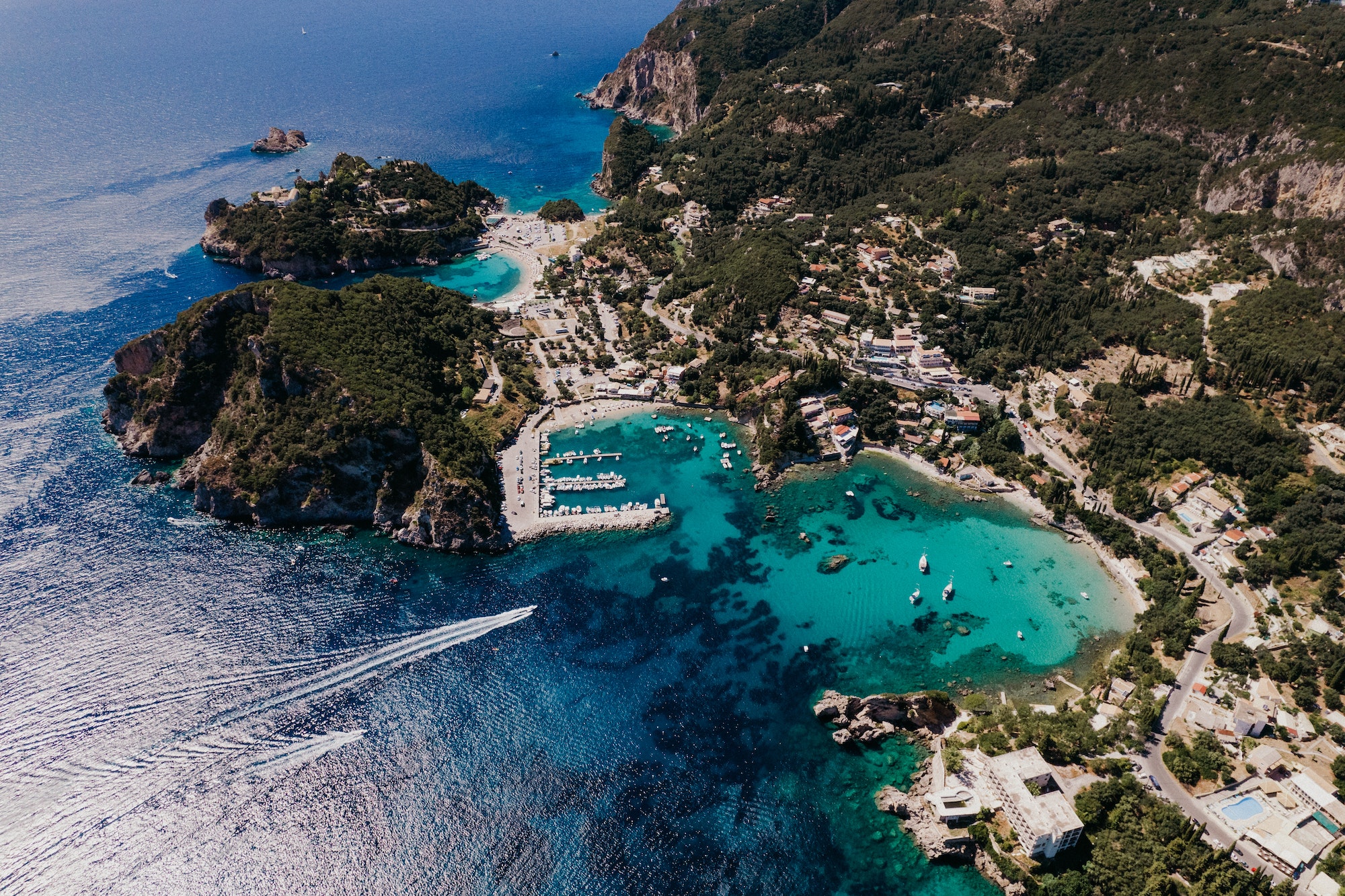 Aerial drone view to Paleokastritsa bay, heart-shaped coast with clear teal sea water. Greece Corfu