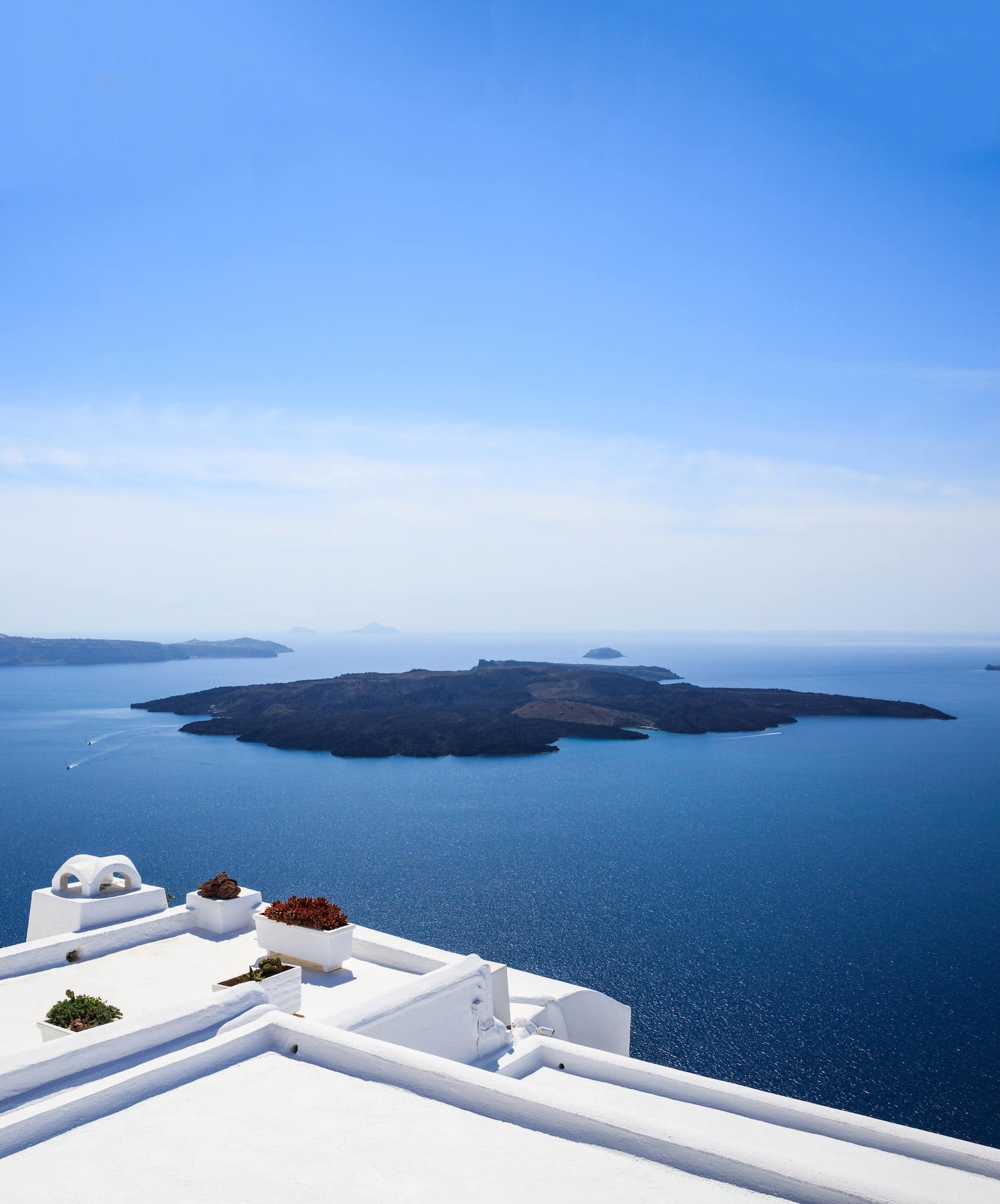 Santorini, Greece. White terrace against blue sea and sky background.