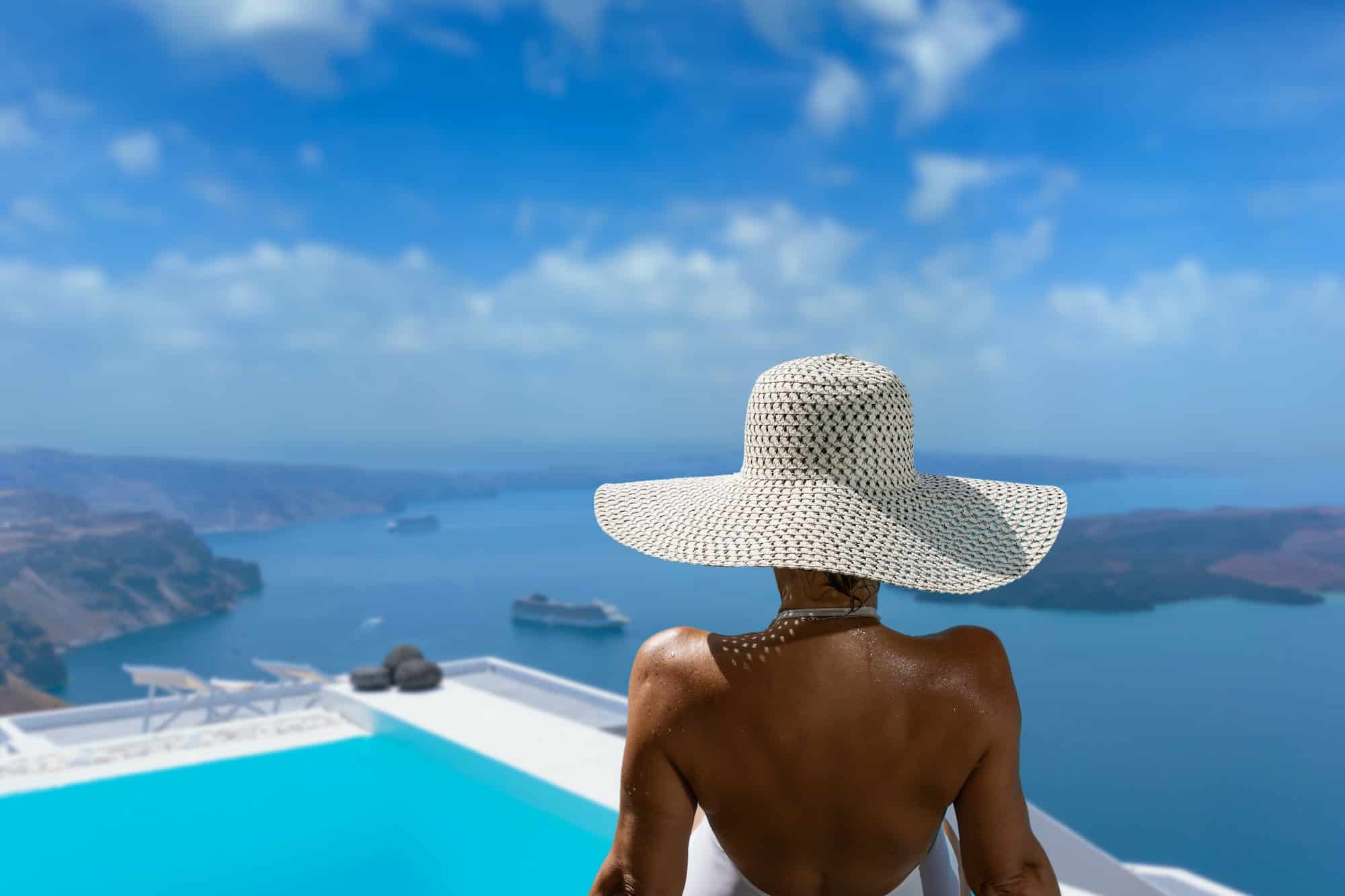 Woman at the swimming pool on the island of Santorini in Greece