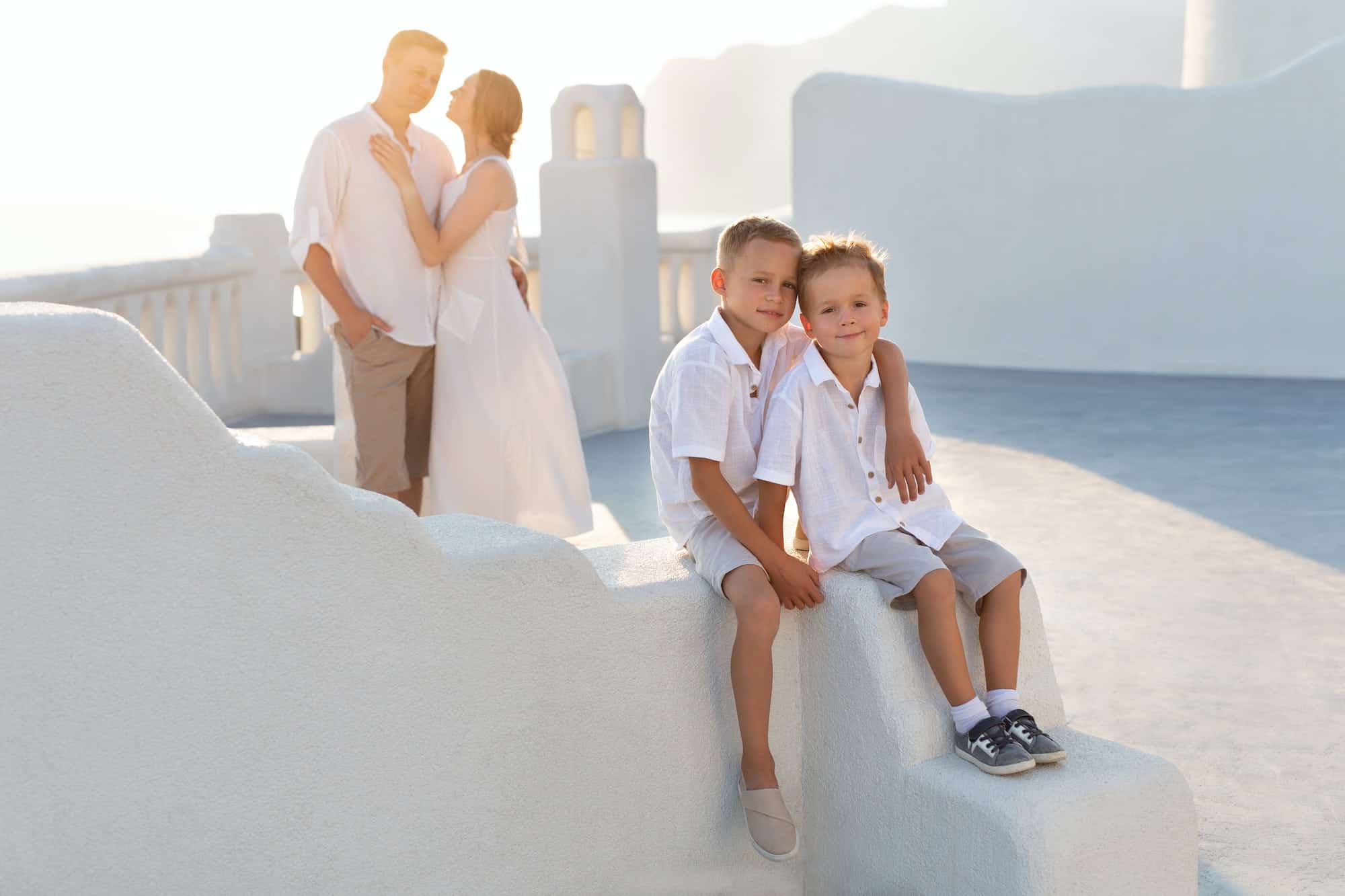 Happy family with children on vacation in Santorini, Greece.