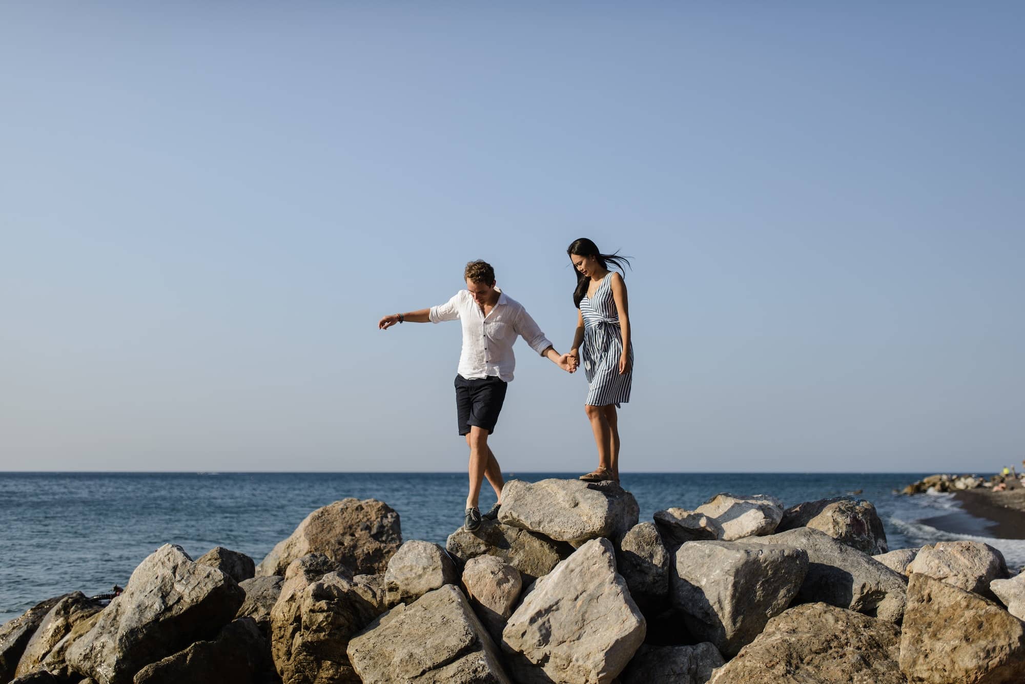 Young couple walking on the background of the sea on the island of Santorini