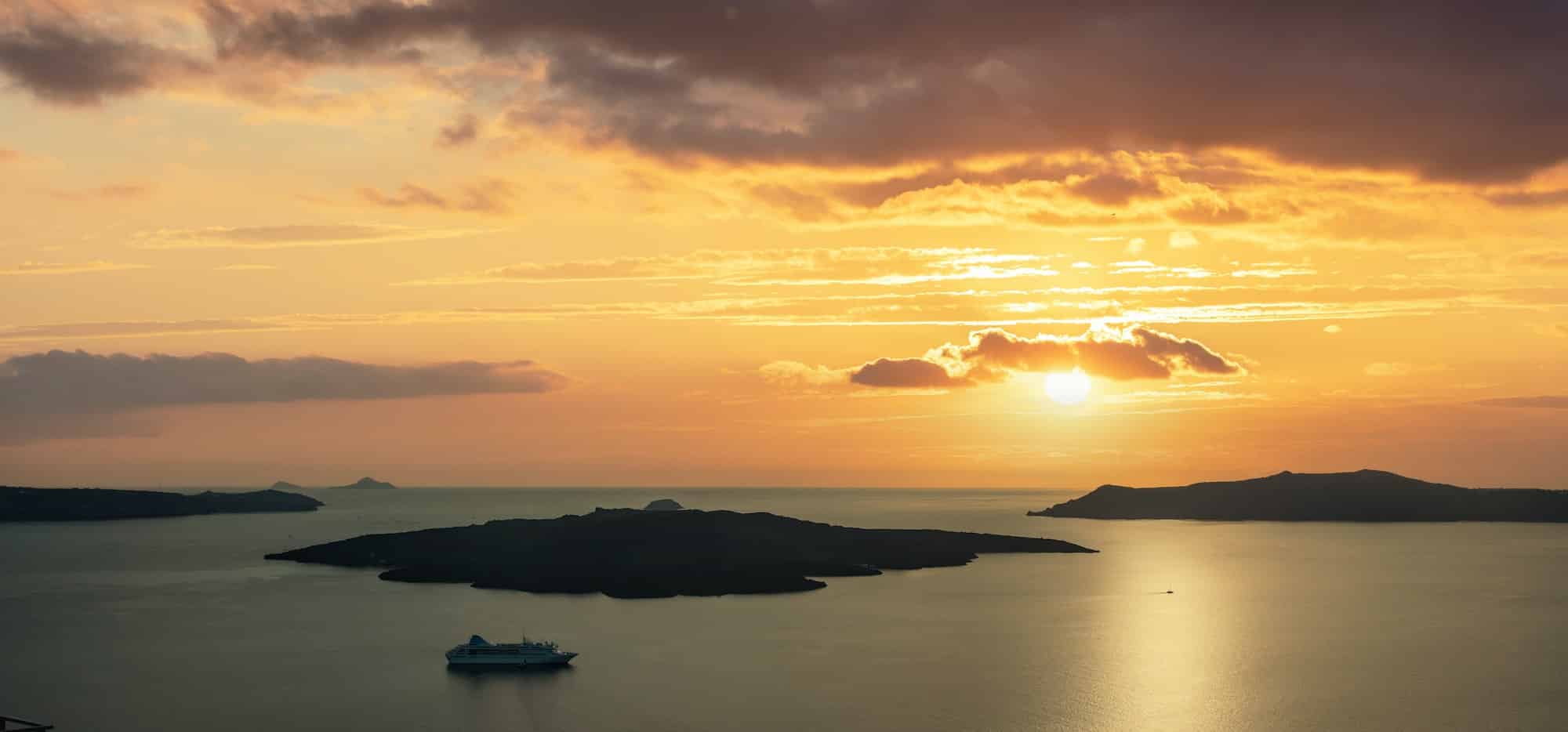 Greek islalnds, Santorini Cyclades, Greece. Sunset over Aegean Sea