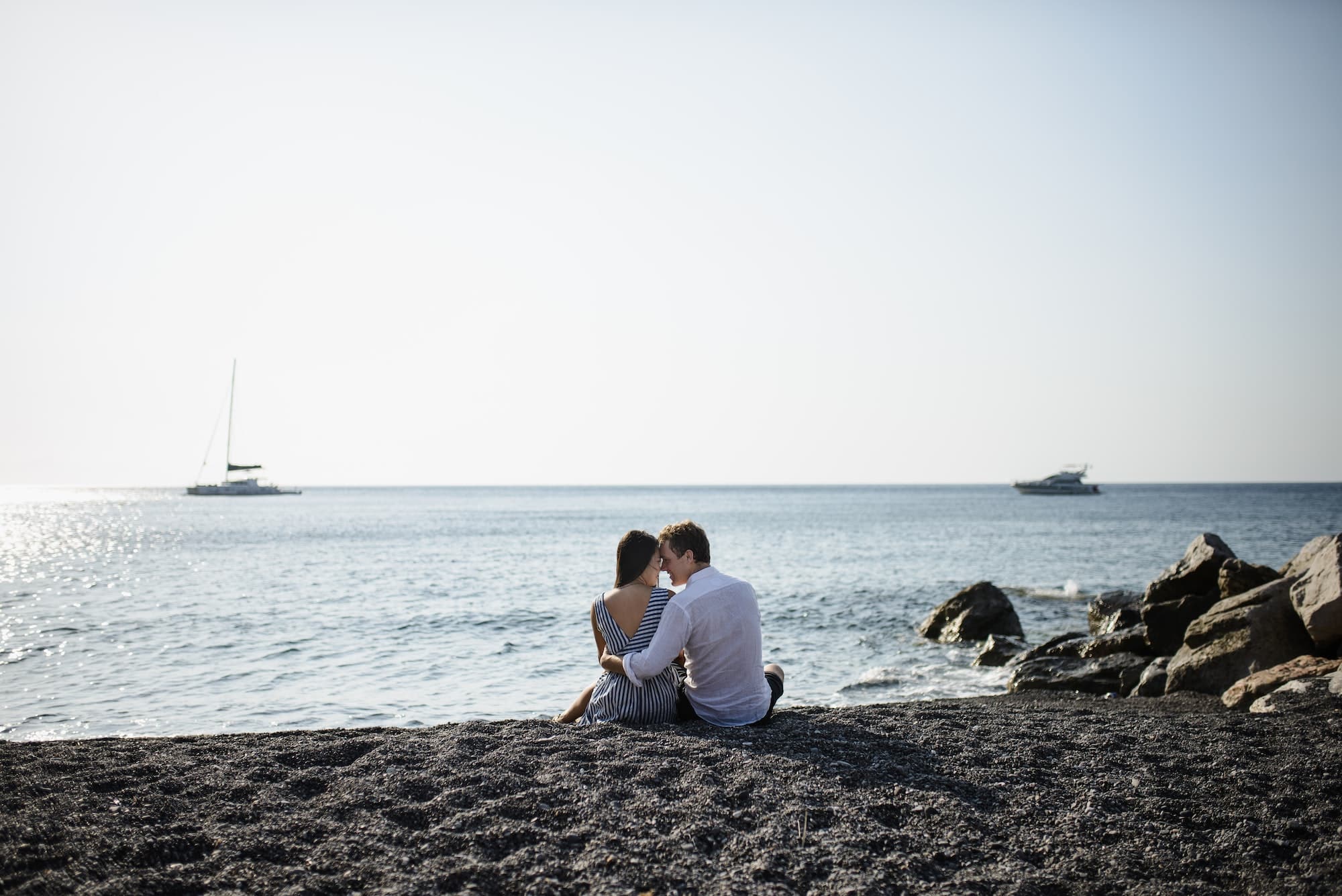 Young couple walking on the background of the sea on the island of Santorini