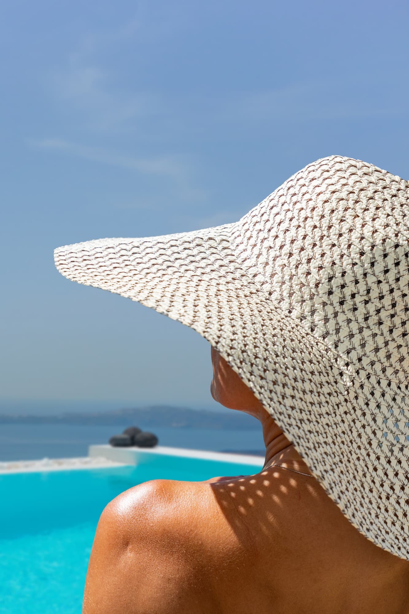 Woman at the swimming pool on the island of Santorini in Greece