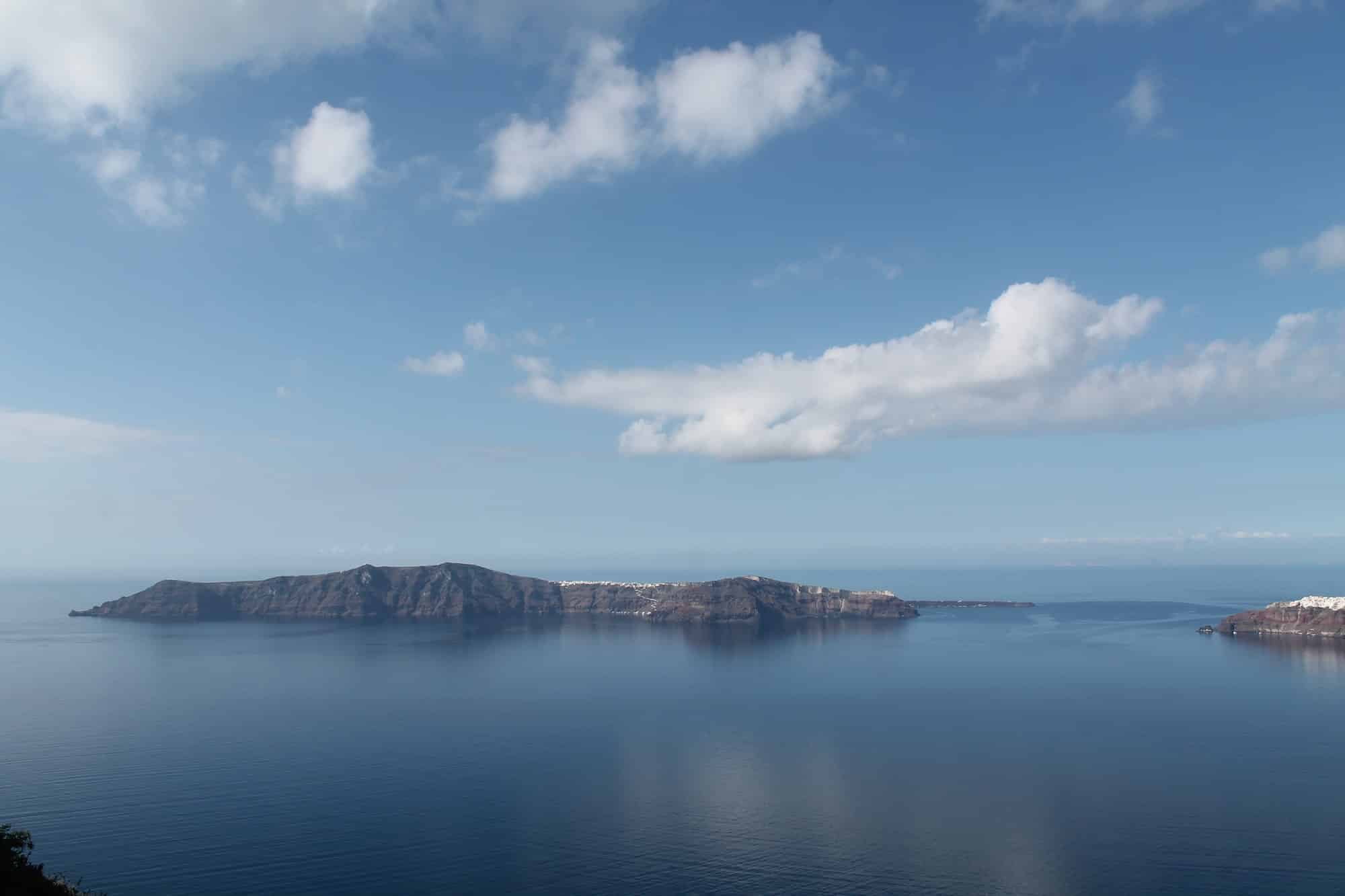 Panoramic bird's eye view of the blue sky and bright sea on the island of Santorini, Oia, Greece
