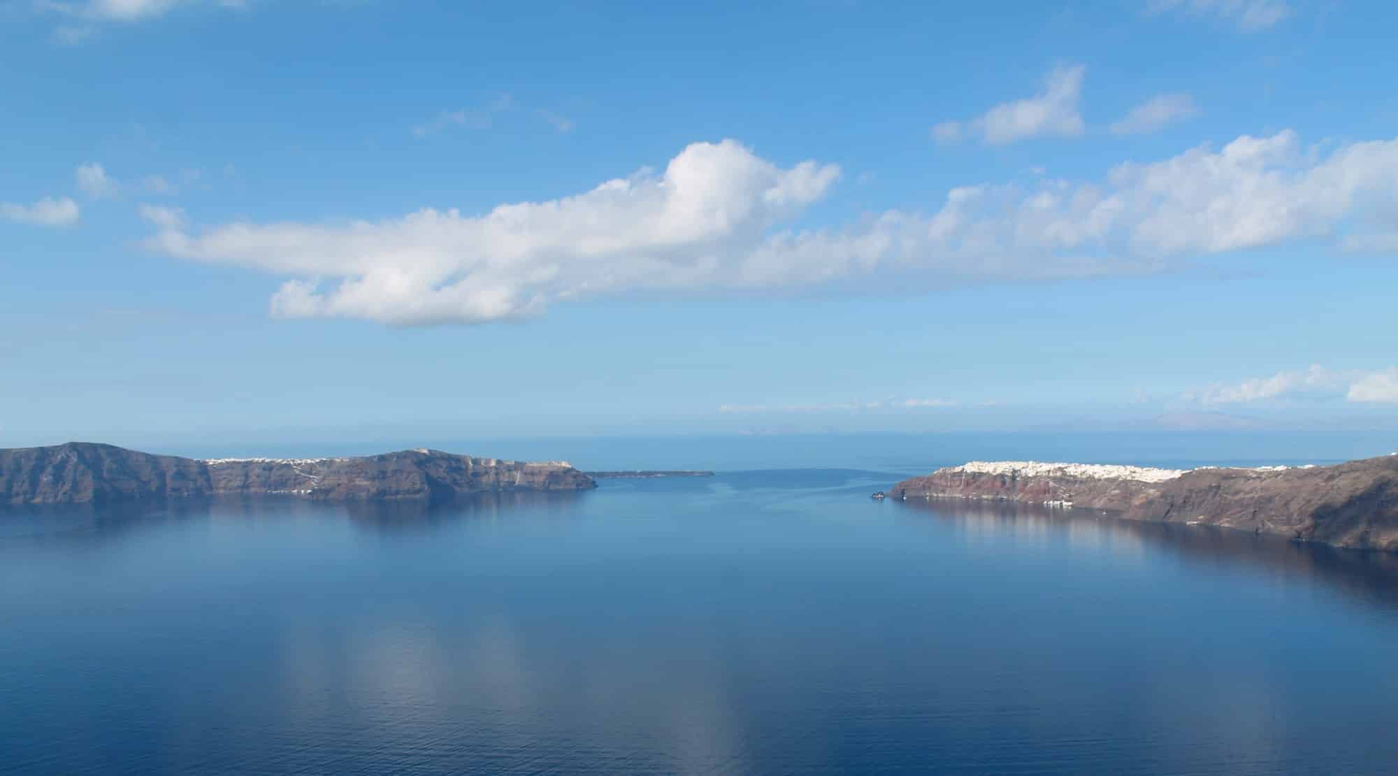 Panoramic bird's-eye view of the blue sky and bright sea on the island of Santorini, Oia, Greece