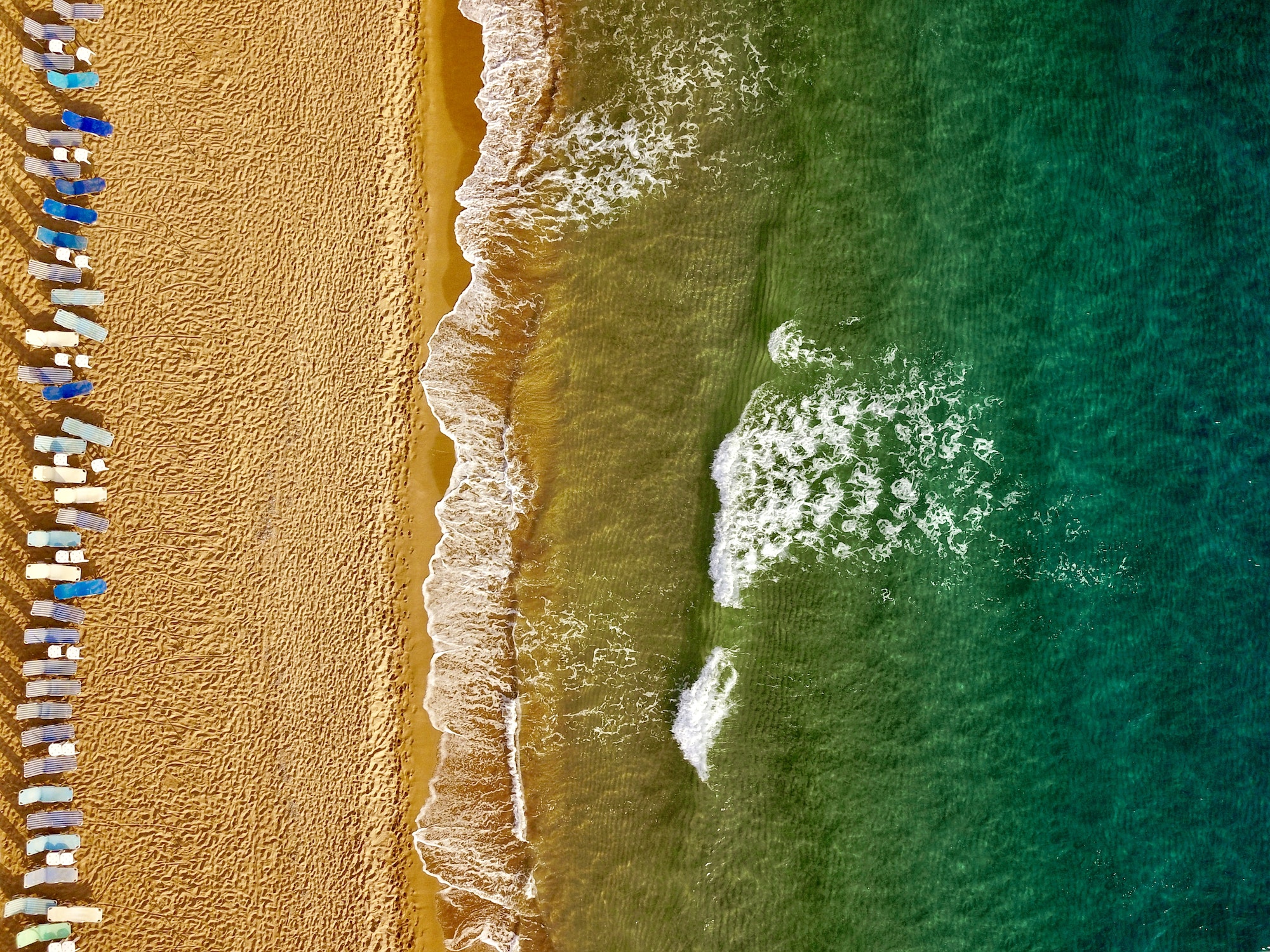 Top view of the beach and sun loungers. The deserted coast of th