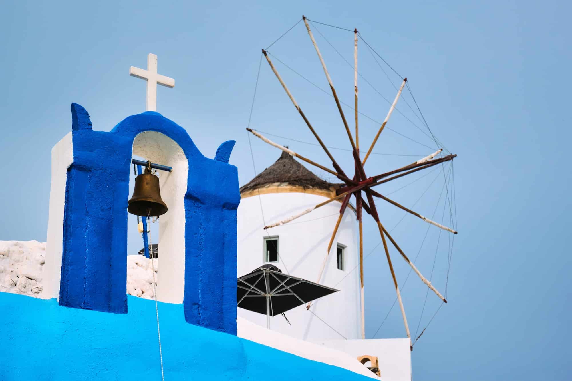 Old greek windmill on Santorini island in Oia town with stairs in street. Santorini, Greece