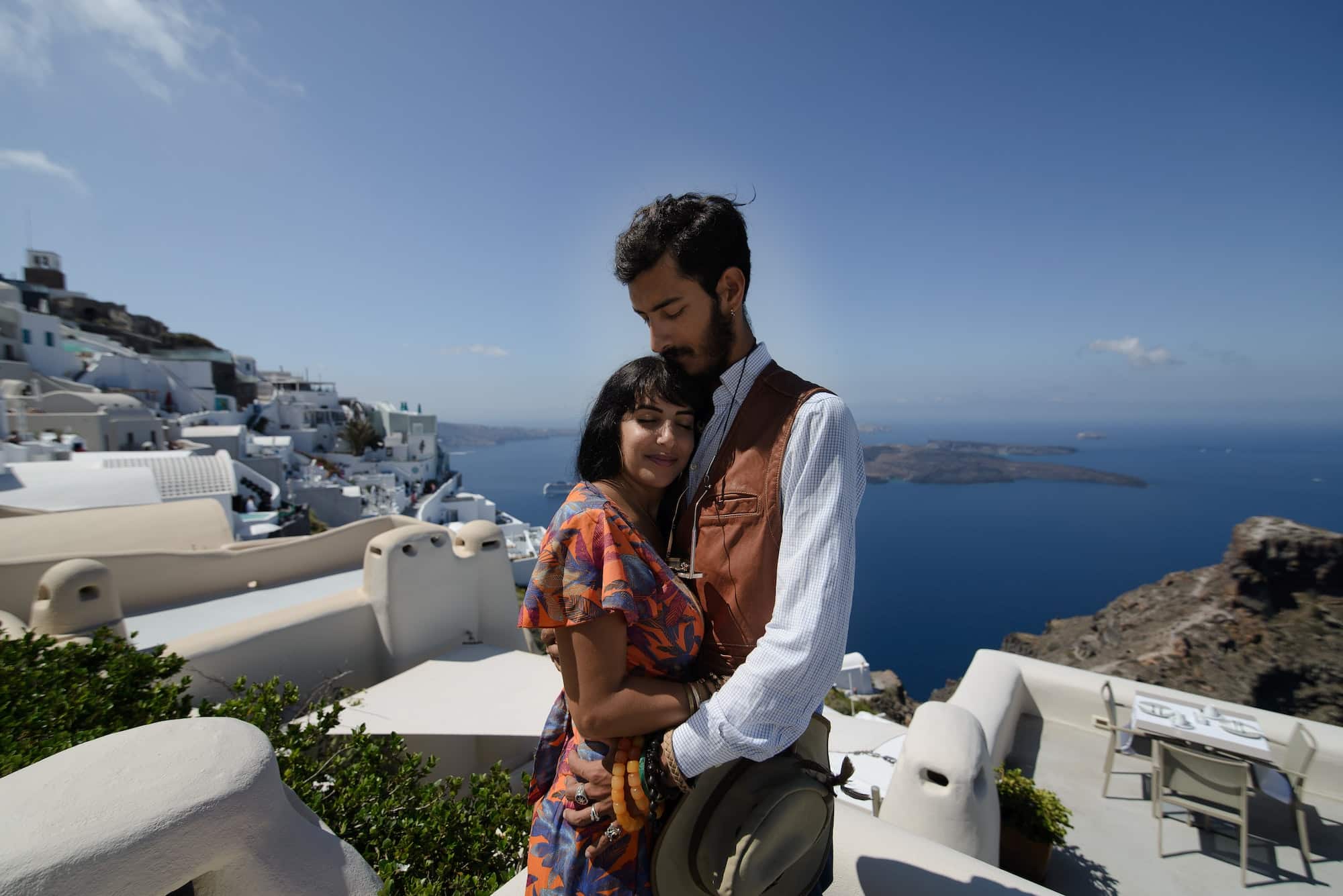 young couple honeymoon on the most romantic island Santorini, Greece. Sunset in the city Oia