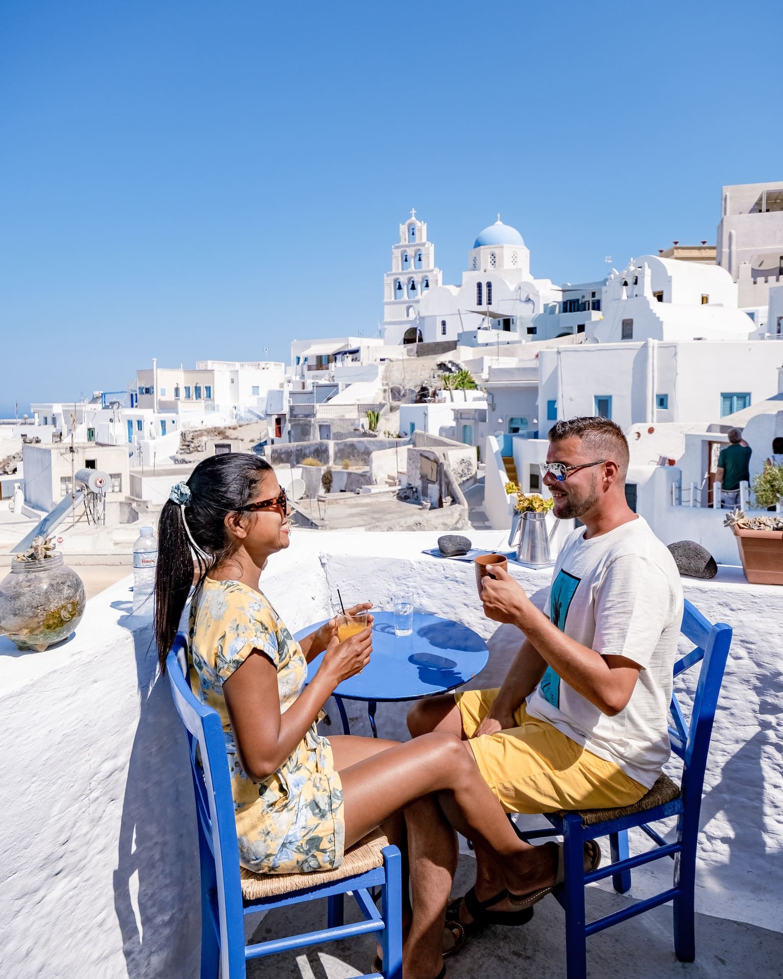 Couple of men and women on vacation in Santorini Greece, couple visit Oia Santorini