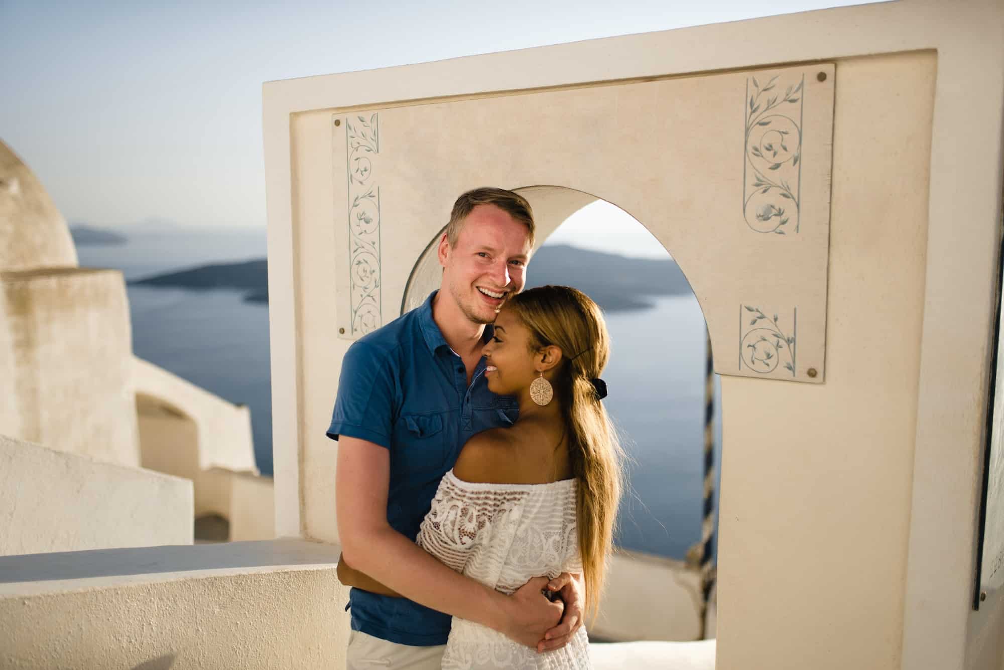 A loving couple walks the streets of the old city on the island of Santorini.