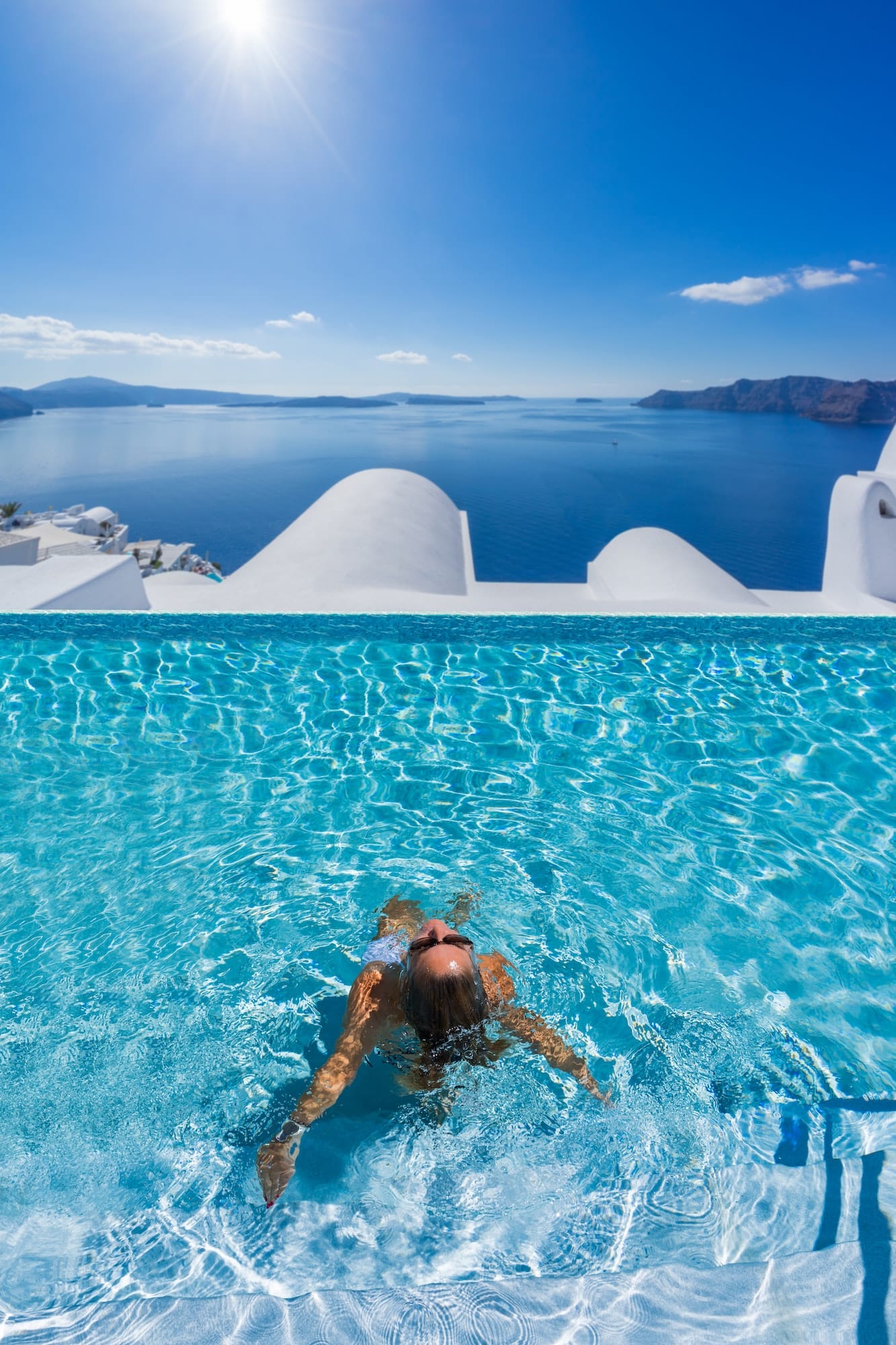 Woman at the swimming pool on the island of Santorini in Greece