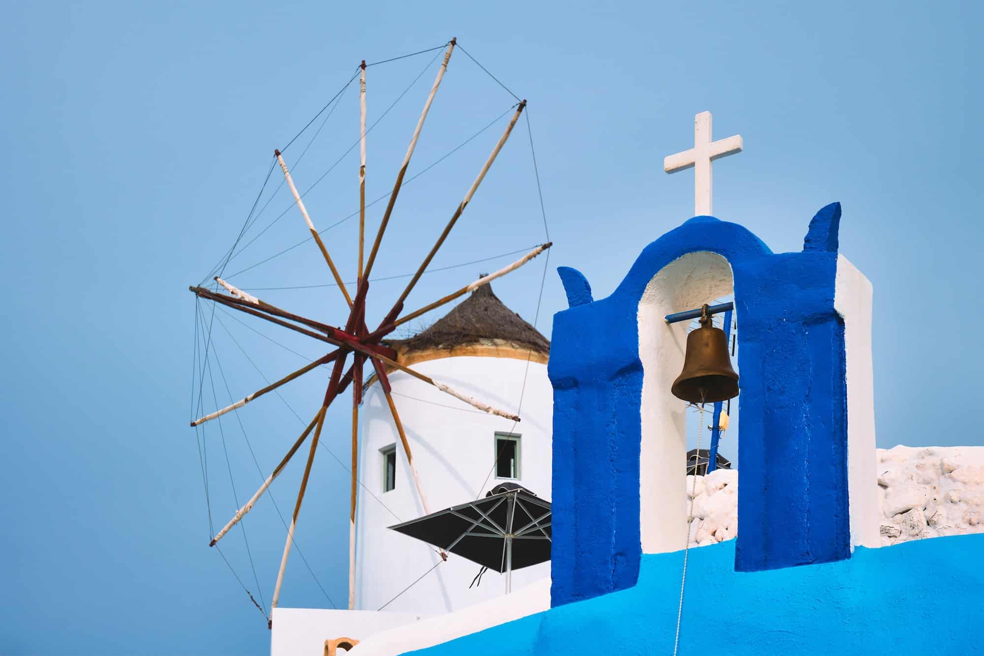 Old greek windmill on Santorini island in Oia town with stairs in street. Santorini, Greece