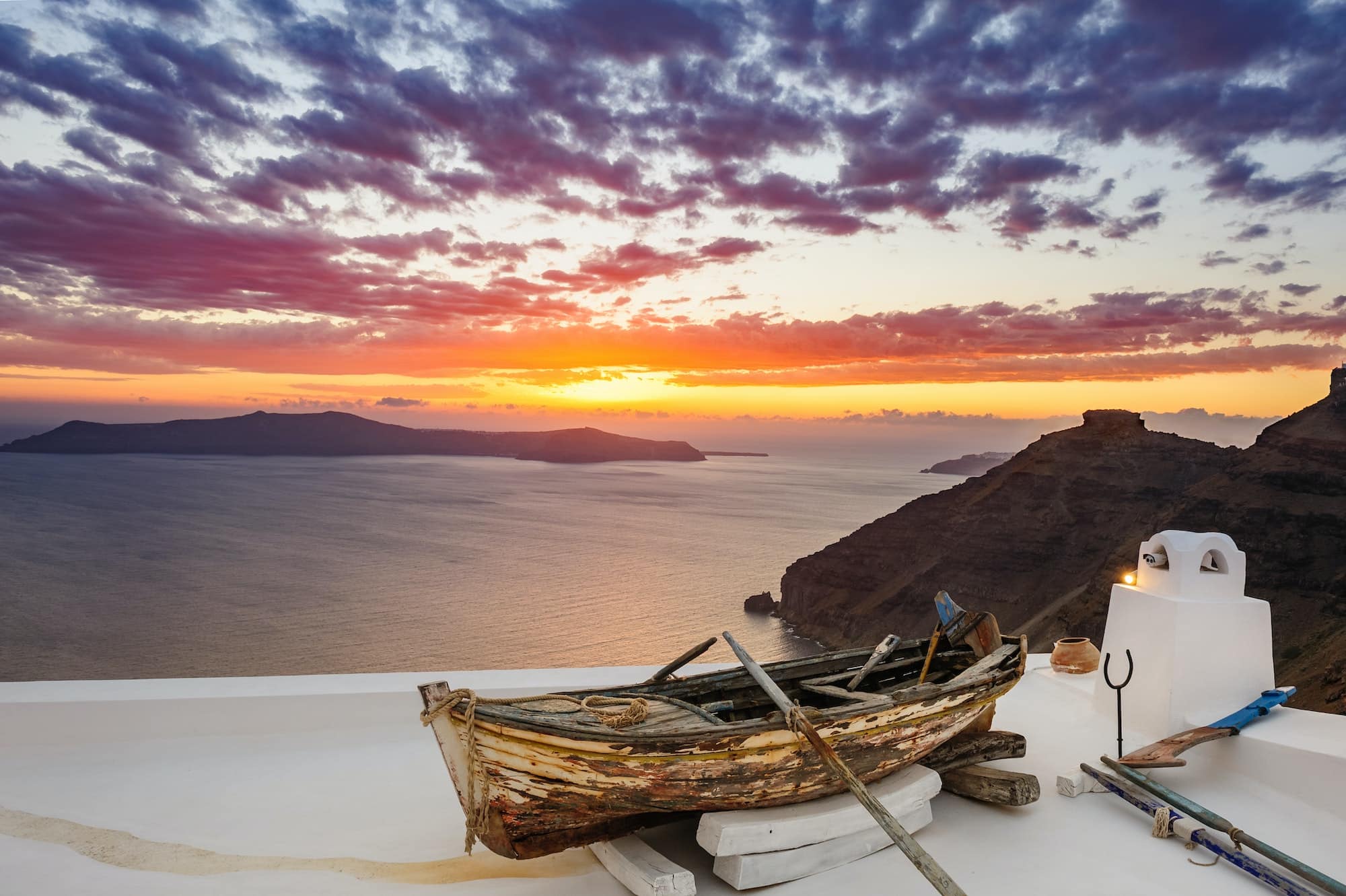Old wooden boat on roof in Firostefani, Santorini island, Greece