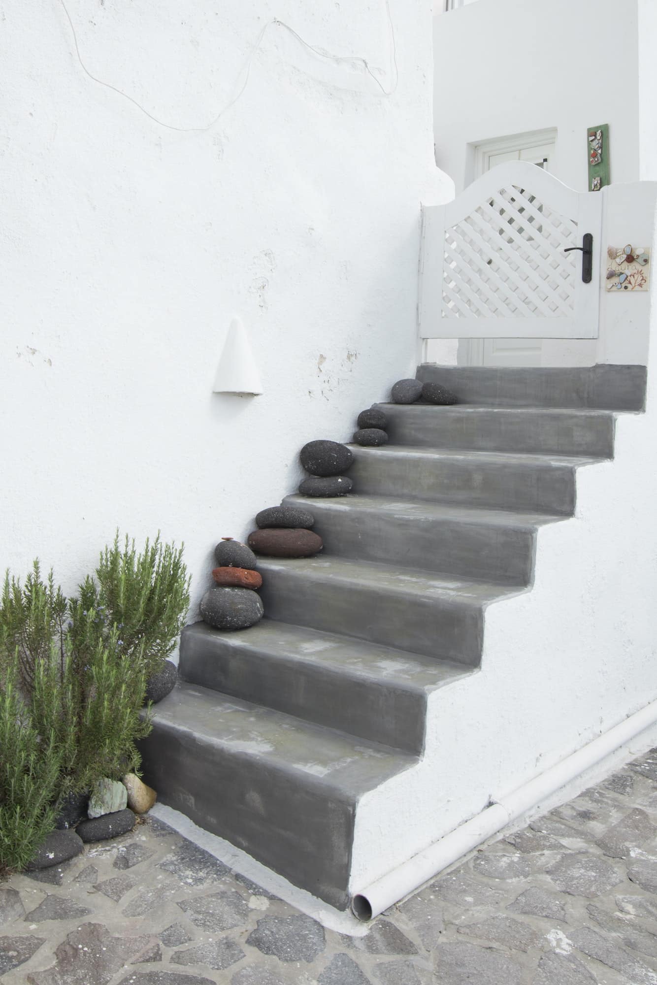 Patio stairs to a white home in santorini