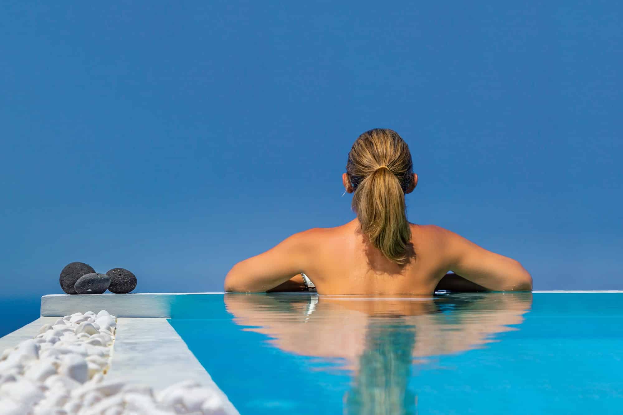 Woman at the swimming pool on the island of Santorini in Greece