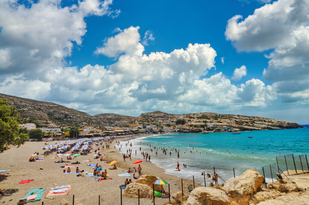 Famous beach of Matala full of tourists, Crete island