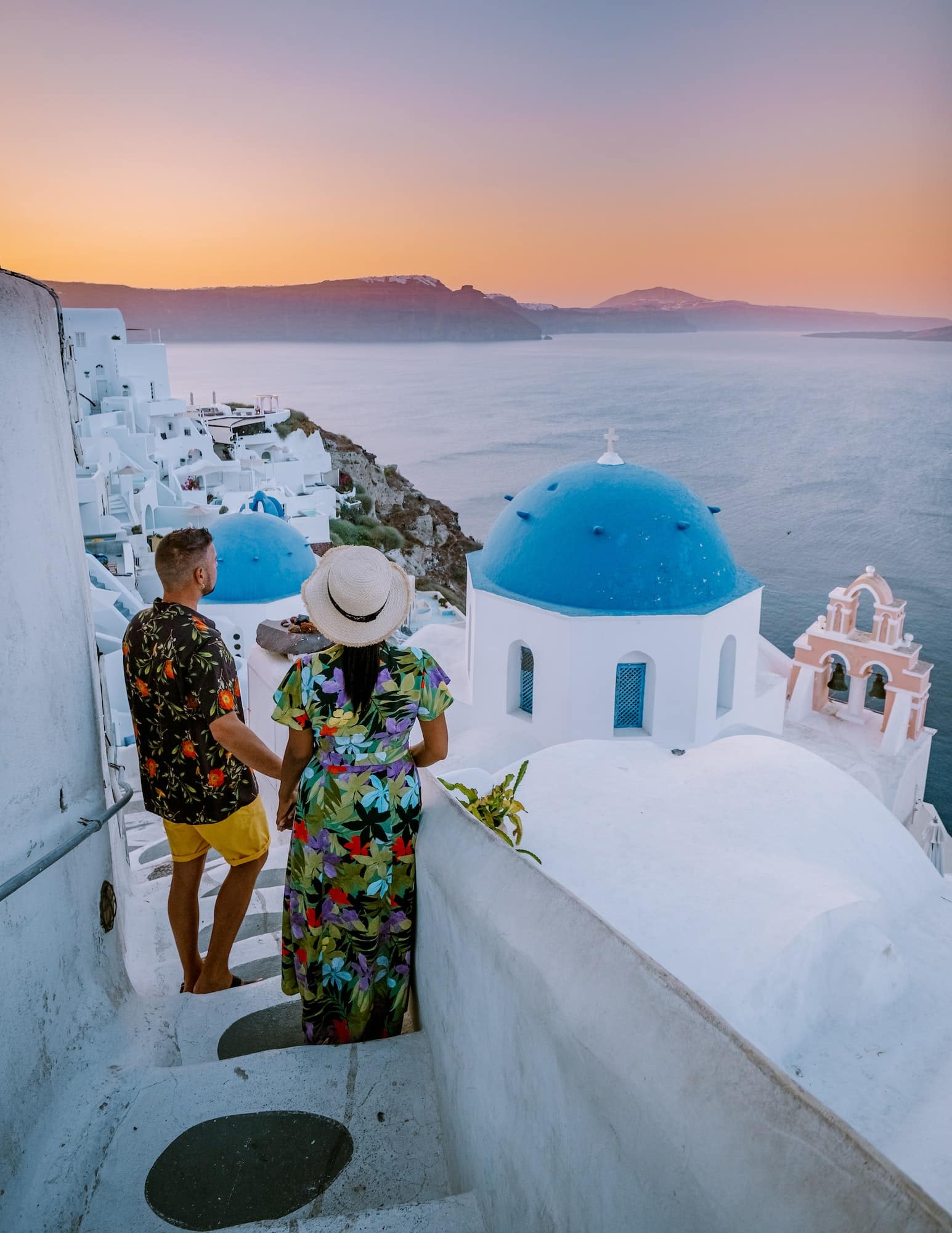 Couple of men and women on vacation in Santorini Greece, couple visit Oia Santorini
