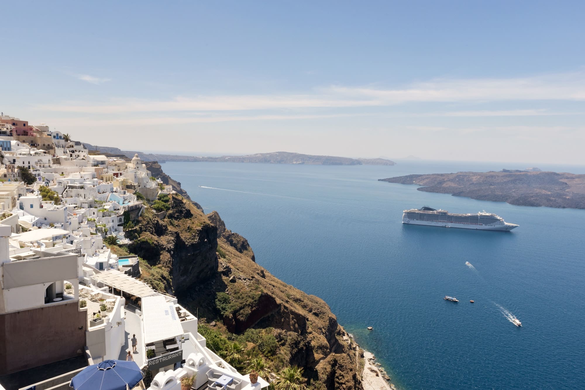 Ship Sailing In Sea Against Santorini