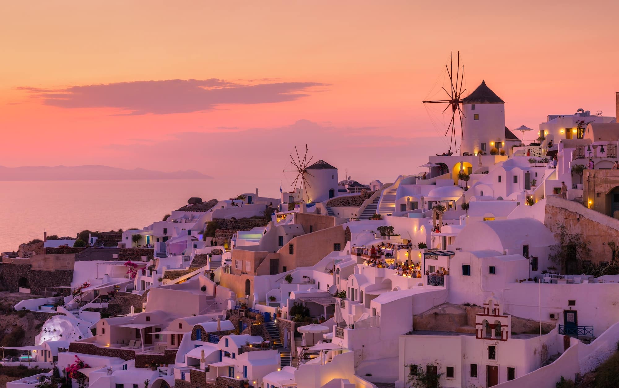 Oia village, Santorini, Greece. View of traditional houses in Santorini. Sunset time.