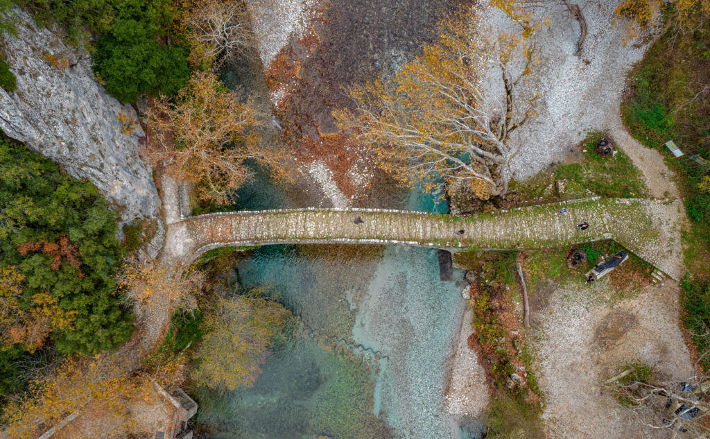 Top down aerial view  of the  old stone bridge in Klidonia  during fall season.  This arch bridge was built in 1853and i is situated on the river of Voidomatis in  Zagori, Epirus Greece.
